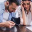 Worried couple examining an empty wallet and an unpaid bill, man in blue shirt and woman holding head in frustration, symbolizing bankruptcy decision stress in Arizona