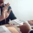 Person in suit extending cash while another in suit raises hand to refuse it, symbolizing integrity and rejection of bribery or wage garnishment workaround