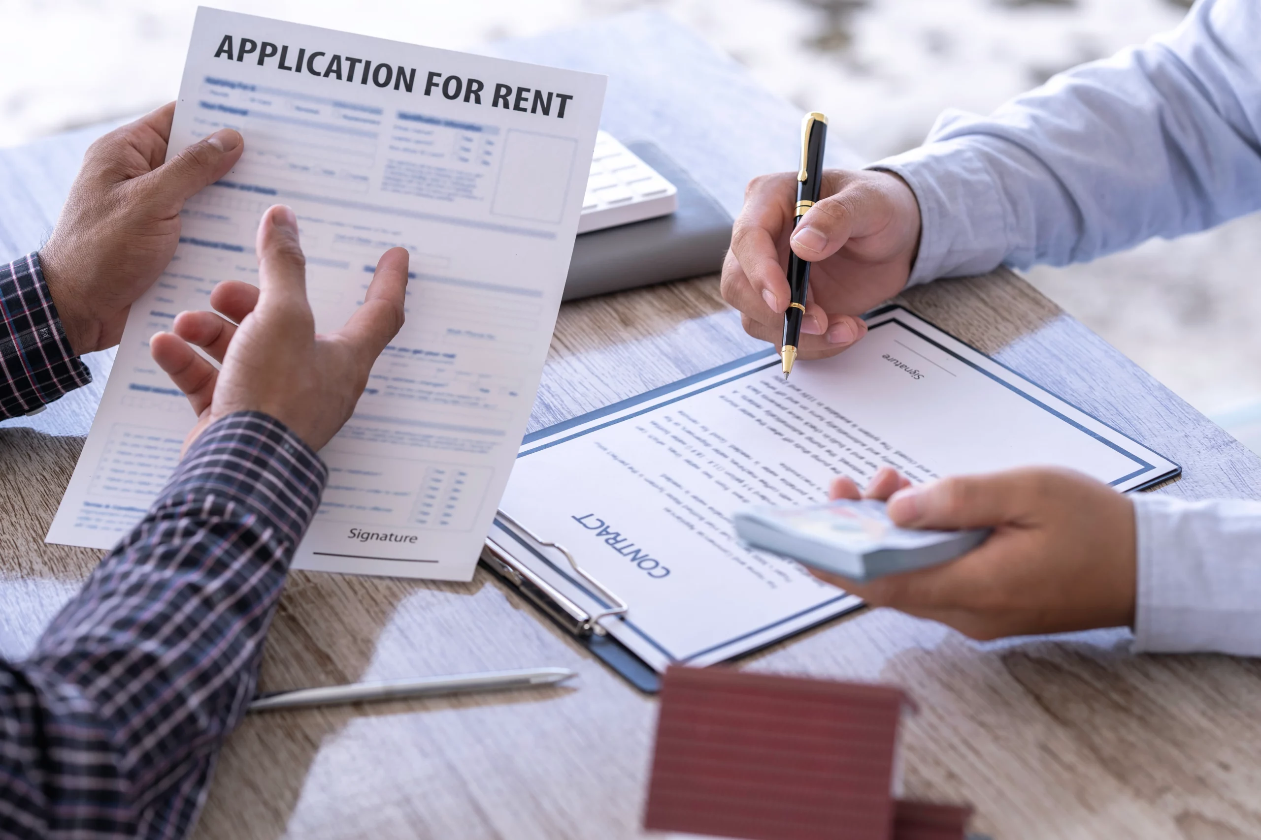 Person reviewing unpaid bills while consulting financial documents at home, illustrating how certain debts may remain legally required even after bankruptcy and continue to affect personal financial obligations.