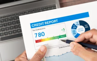 Credit report being reviewed with a pen, representing the impact of Chapter 7 bankruptcy and how long it remains on a credit report.